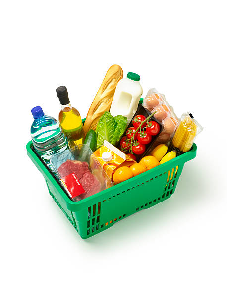 a green basket filled with groceries like milk eggs oil 