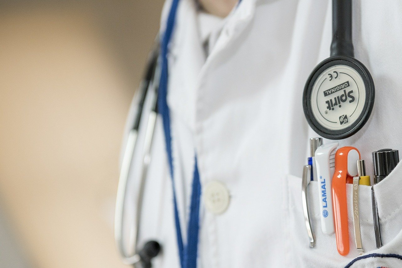 close up of a doctor's coat with a stethoscope around the doctor's neck