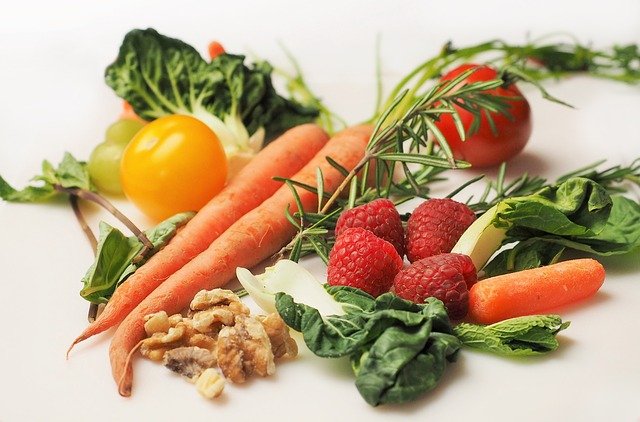 photograph of carrots, herbs, tomatoes and other healthy foods