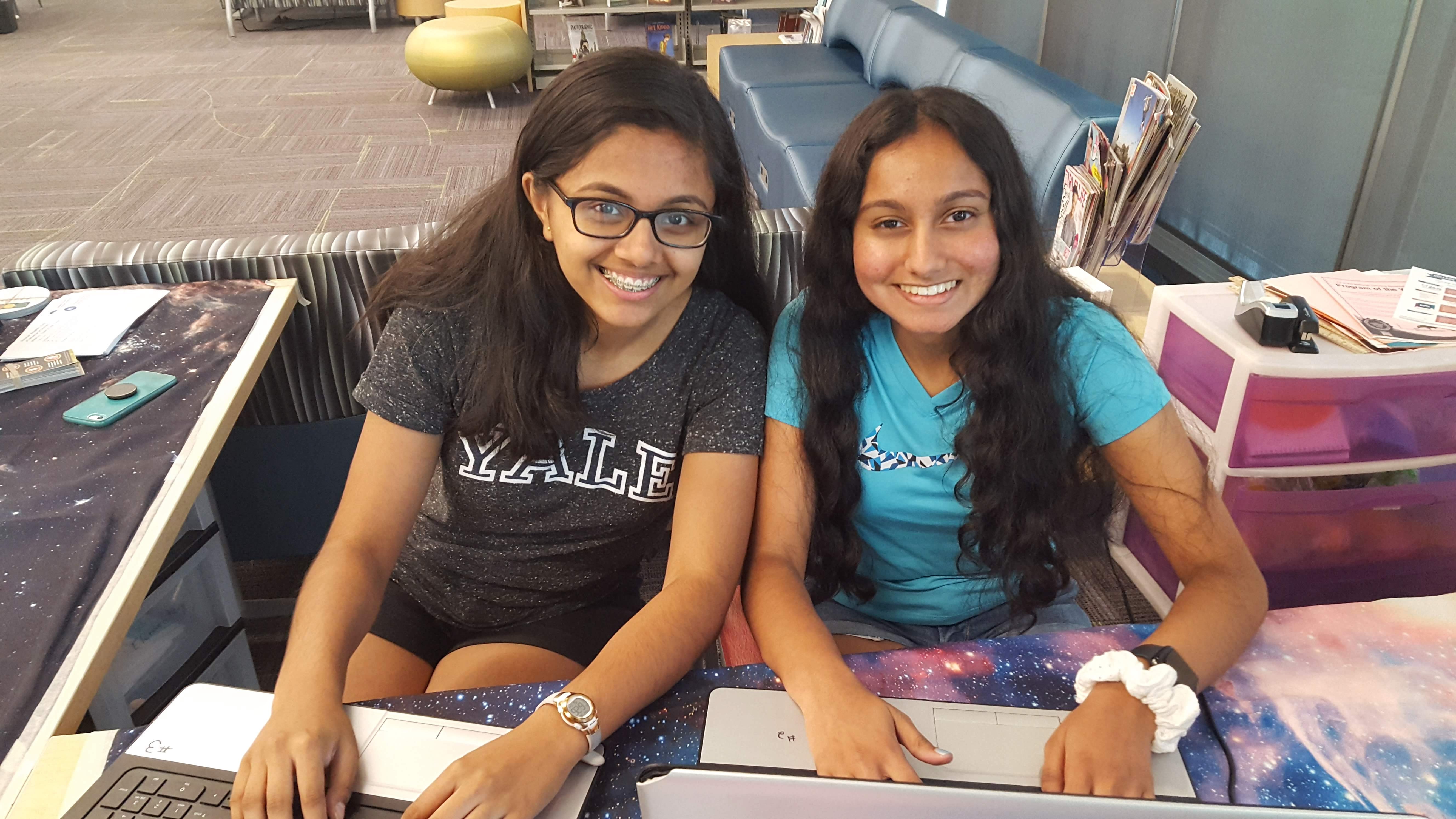 Teen volunteers help with code class