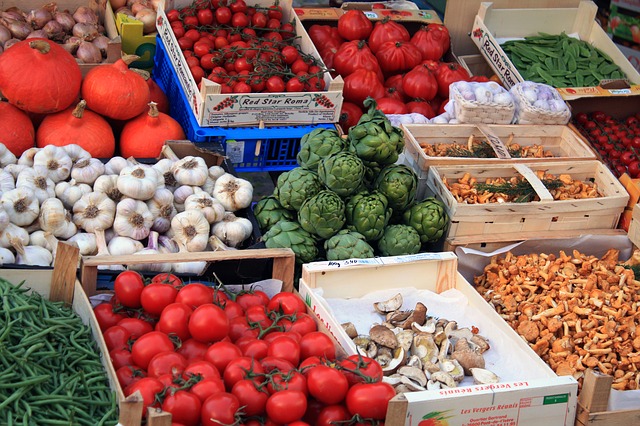 photograph of boxes of vegetables in a market 