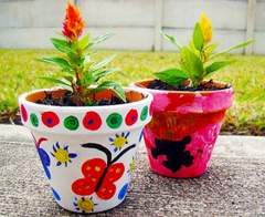 2 brightly painted flower pots