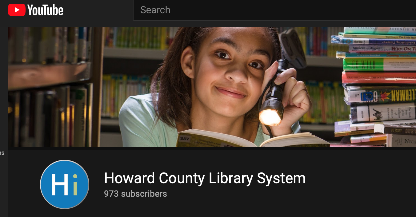 Screen shot of HCLS YouTube channel page featuring a picture of tween girl with a flashlight reading a book with a stack of books next to her
