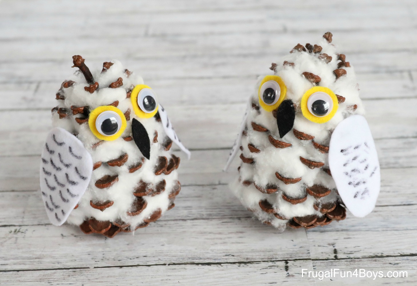 two snowy owls crafted from pinecoes and felt