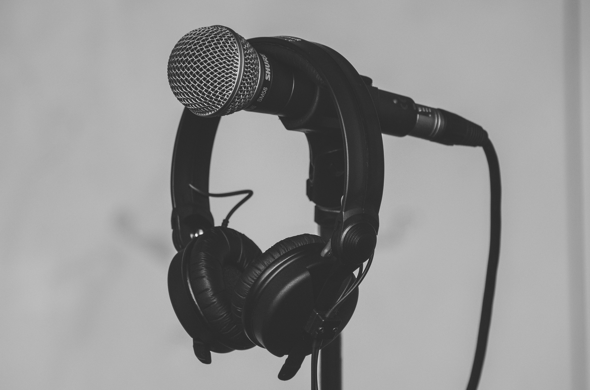 picture of a microphone with a set of headphones hanging off the mic