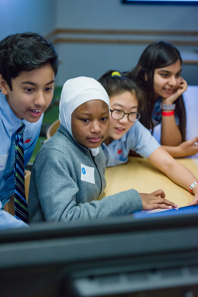 Diverse group of students looking at a computer screen