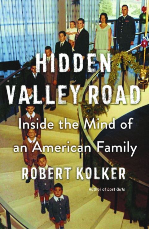 Book Cover depicting family posing on stairs with text of "Hidden Valley Road" overlayed image.