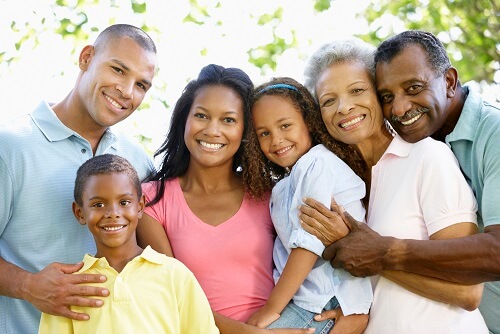 six people of an african american family stand and hug 