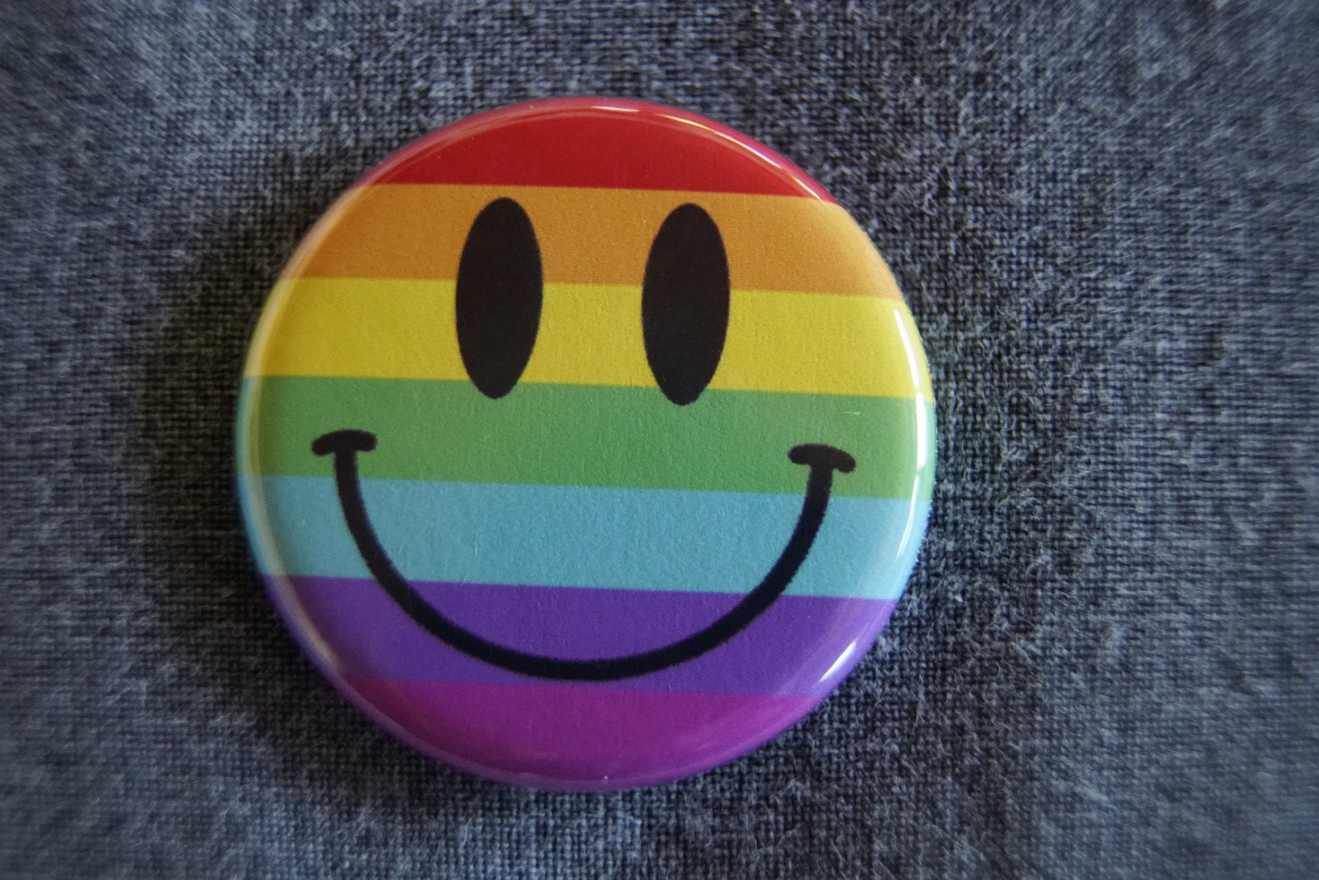 smiley face on a rainbow button