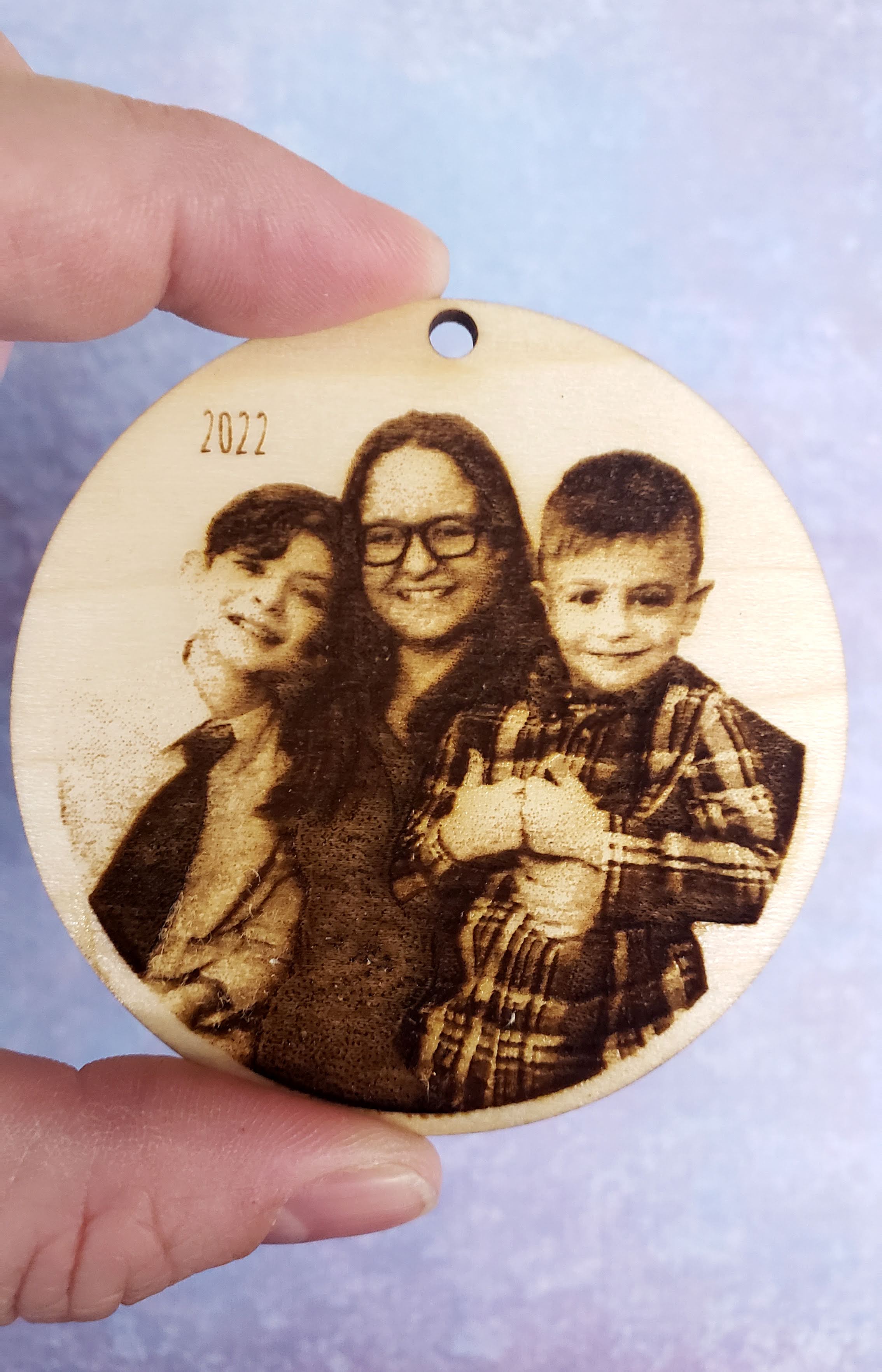 mom with 2 boys photograph engraved on wood with text reading 2022