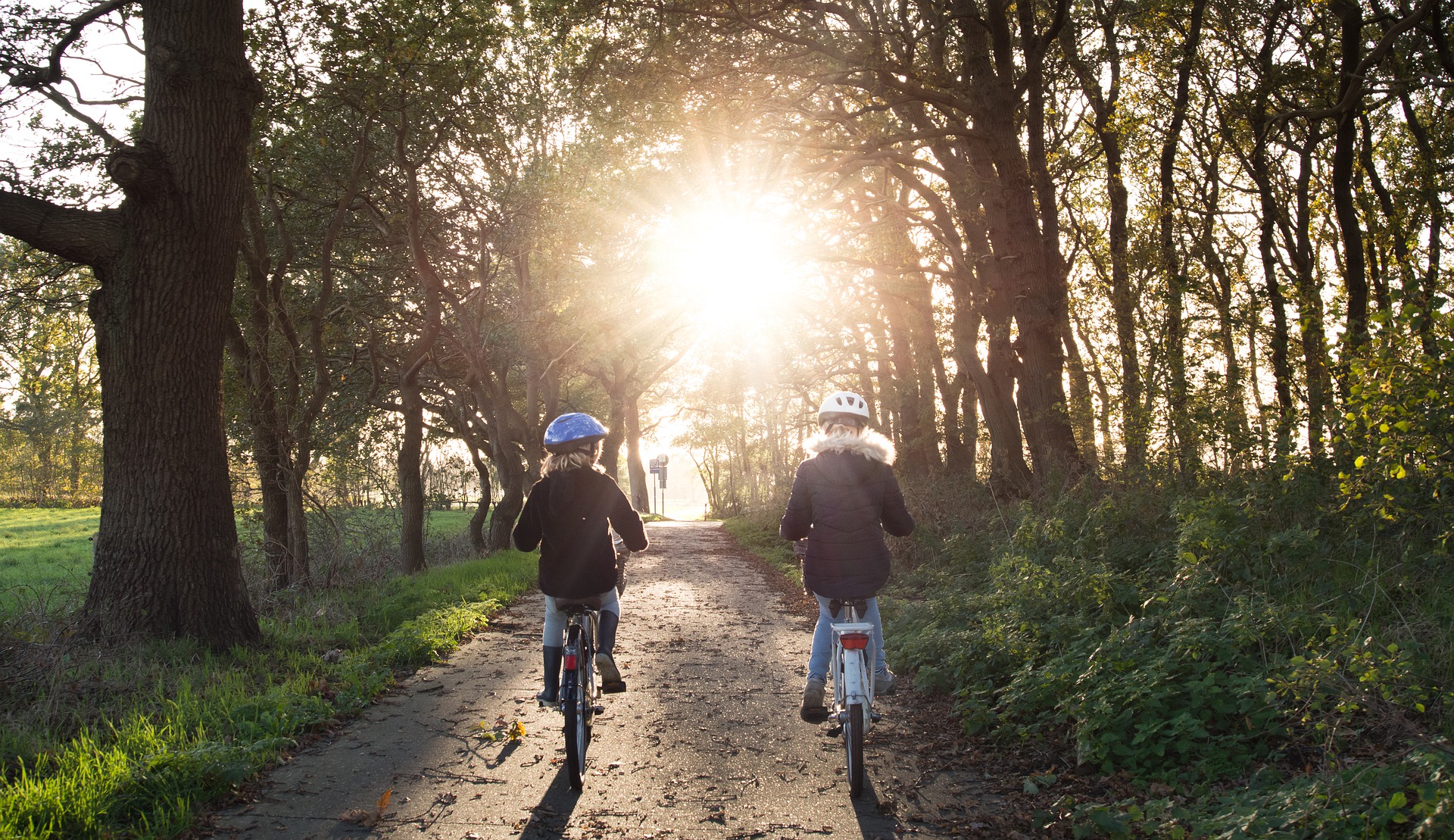 Kids riding bikes into sunset