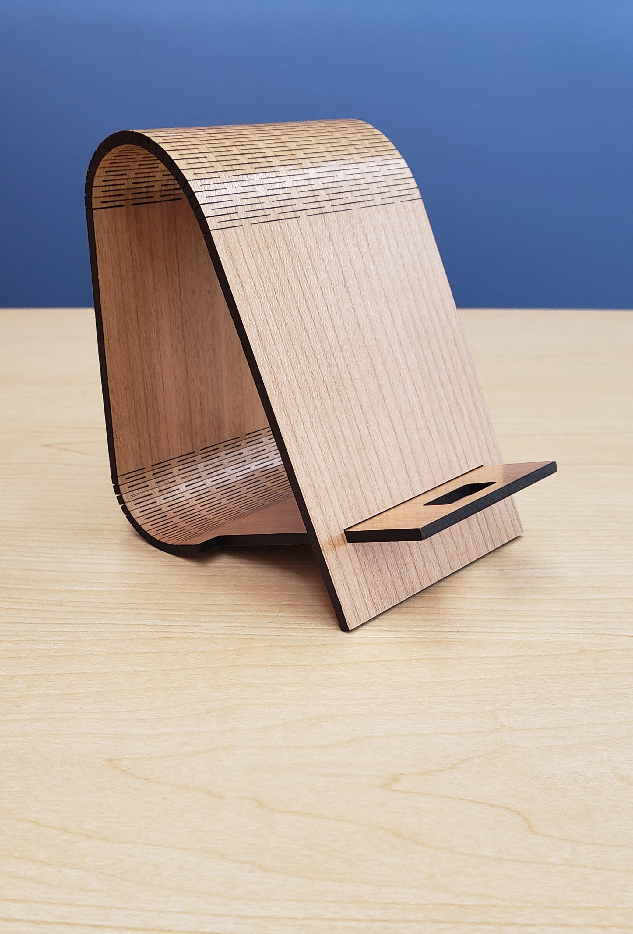 wooden cell phone holder shown on a table