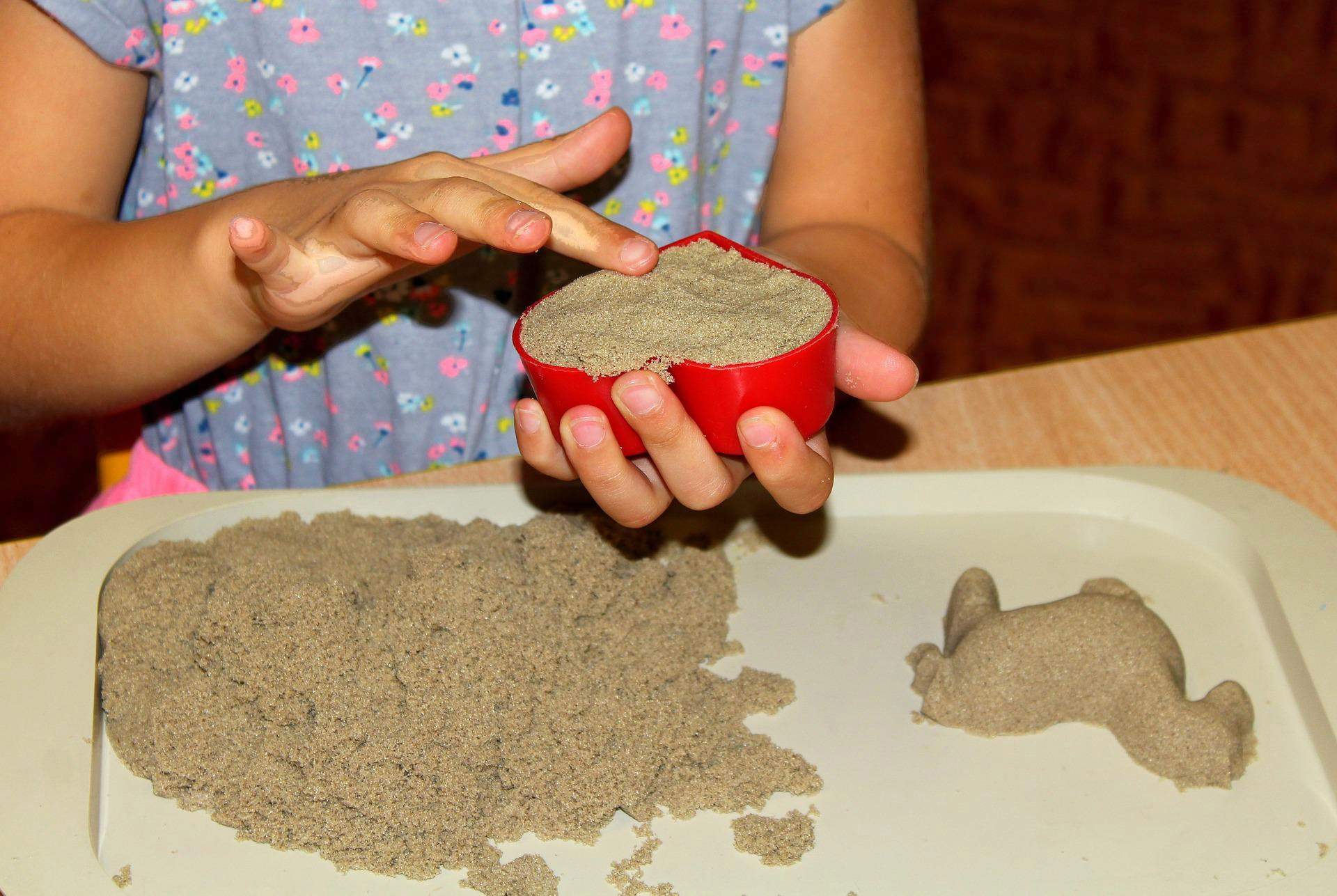 child playing with kinetic sand