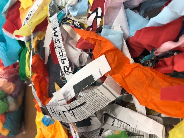 Photo of torn colorful paper and newspapers