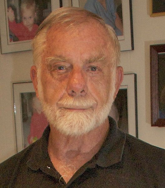 Headshot of author wearing a dark shirt and white beard