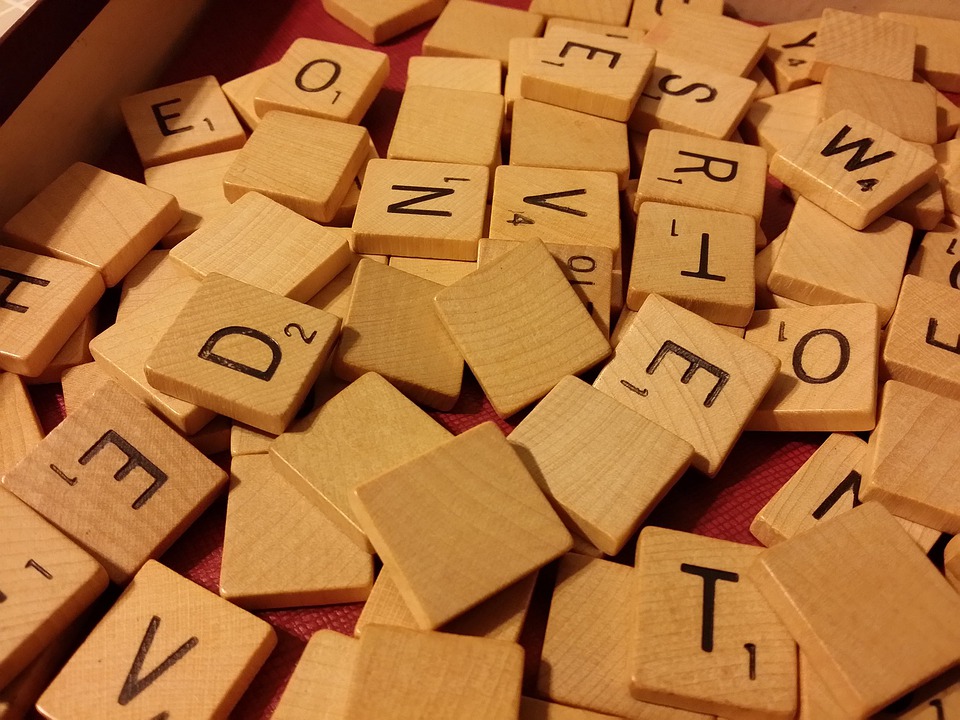 tan scrabble tiles with letters on them