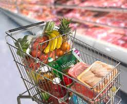 grocery cart filled with produce and meat