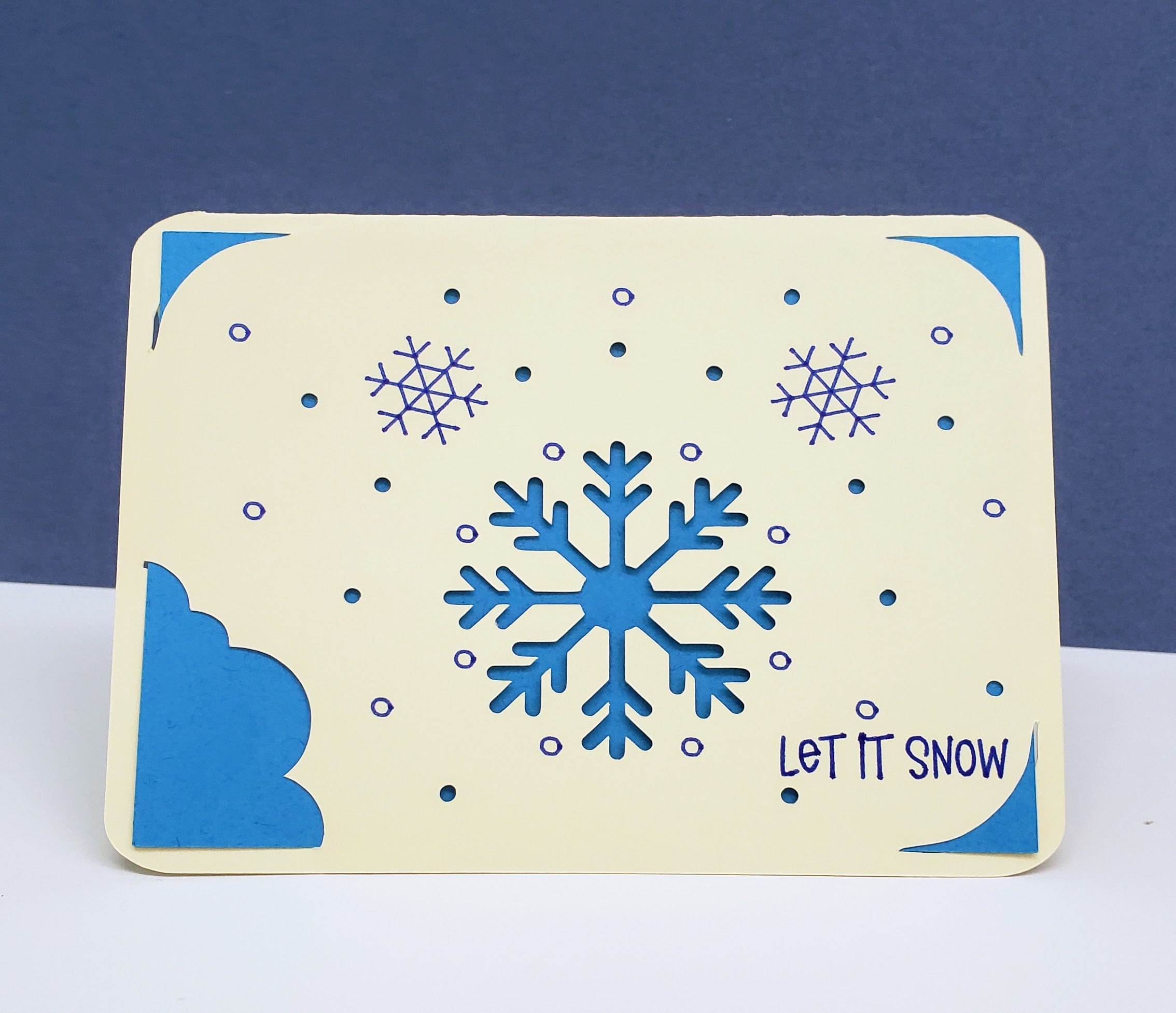 Tan and blue card with snowflakes says "Let it snow"