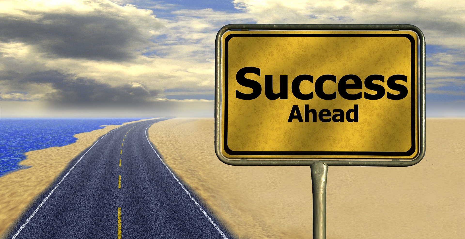 Image of a yellow road sign in the foreground with text saying "success ahead" and in the background an open road