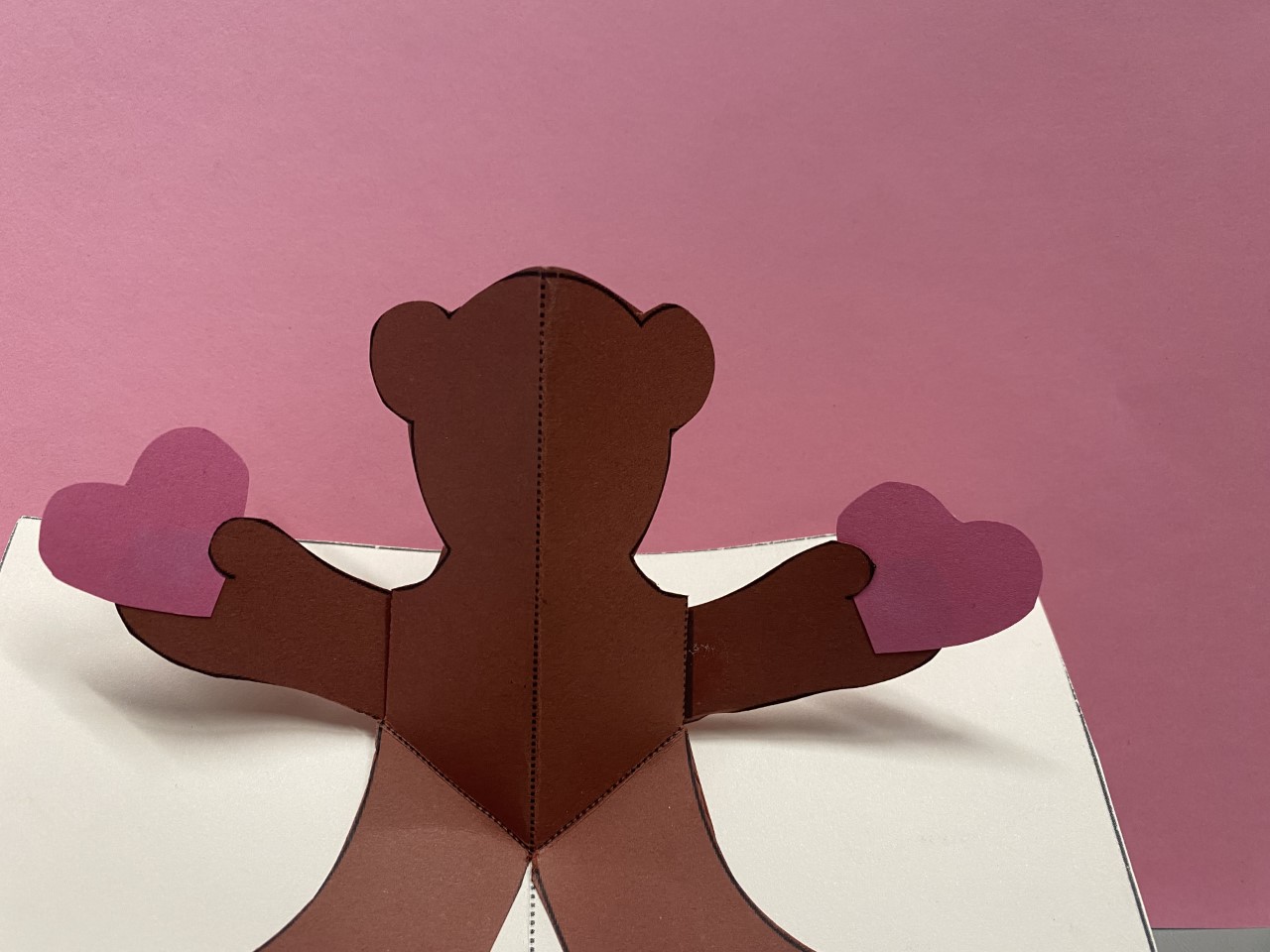 image of a pop up card of a bear holding hearts