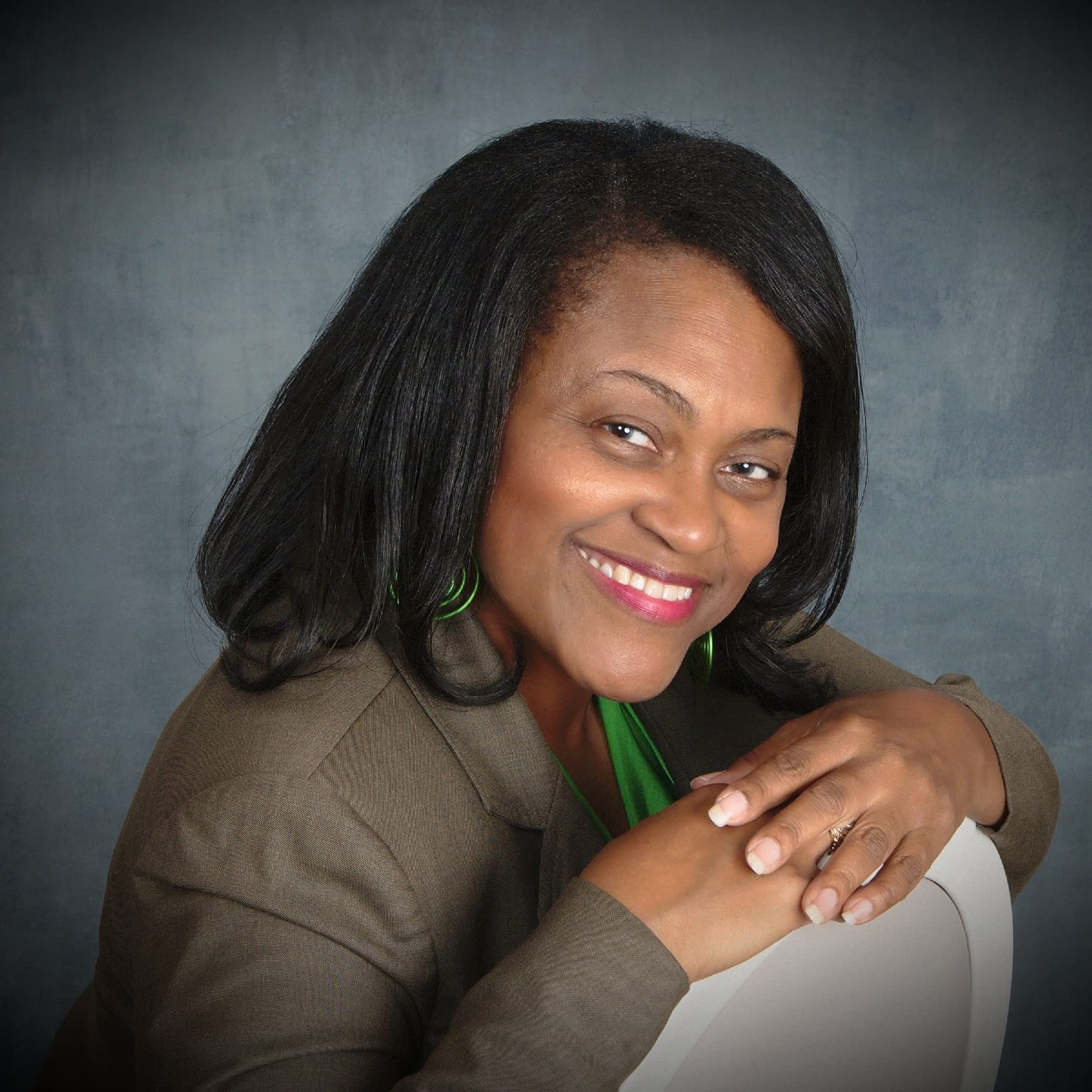 Author head shot: Black woman smiling with gray shirt