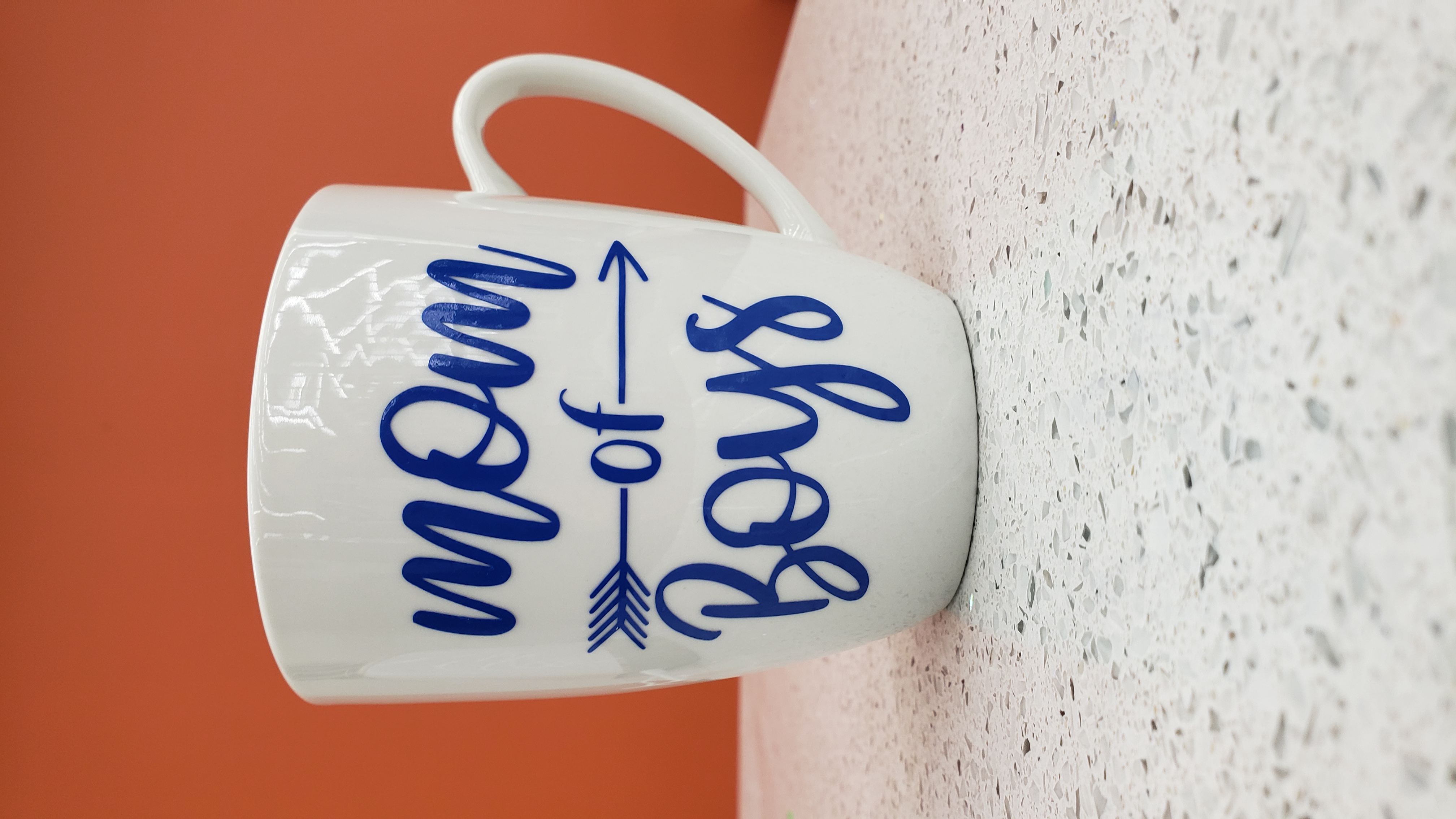 White Mug with blue lettering says "Mom of Boys"