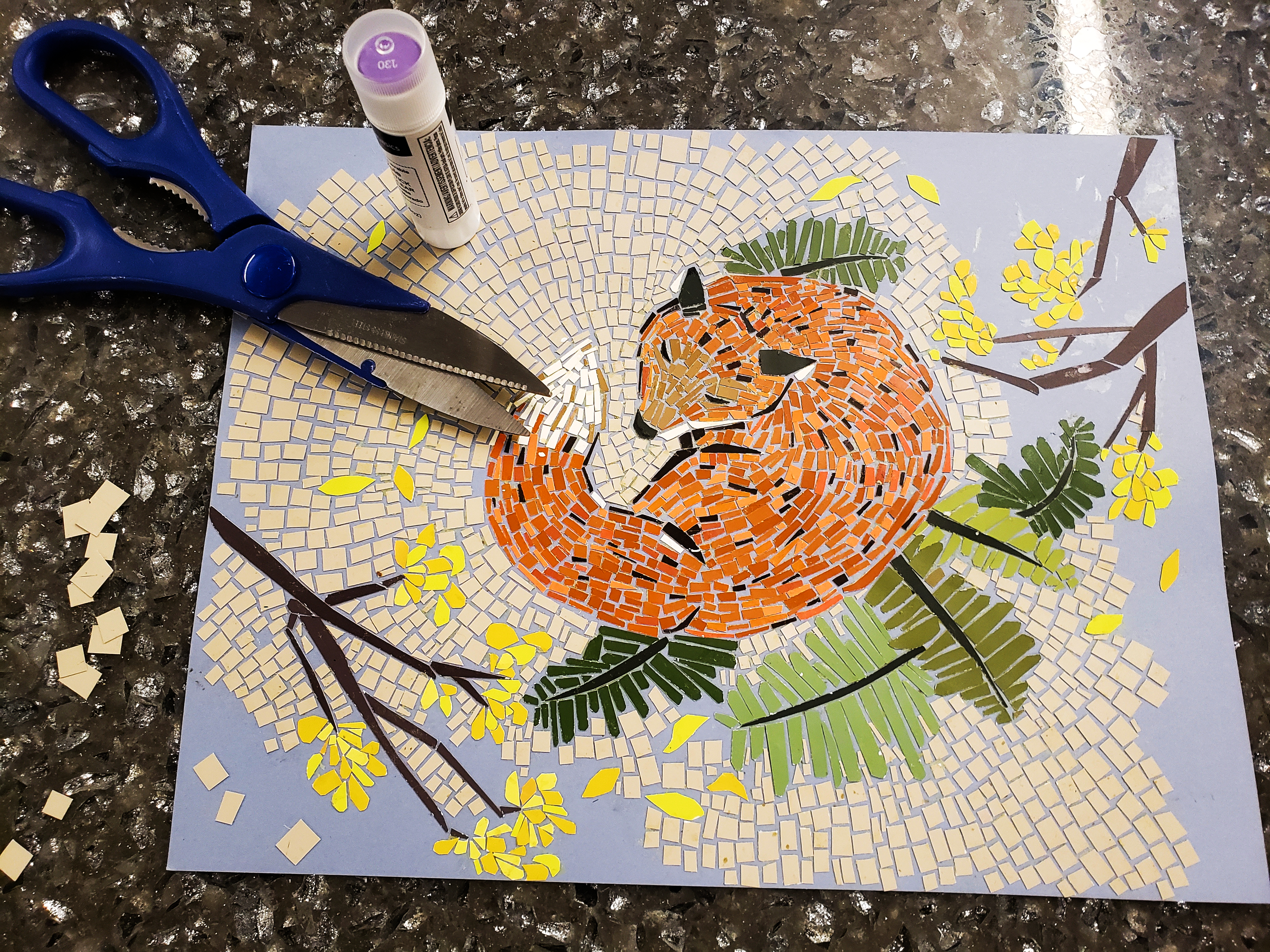 paper mosaic of a fox with scissors and glue stick