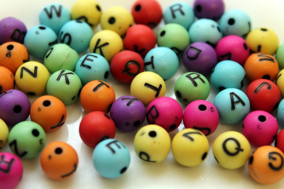 rainbow colored beads with random letters on them