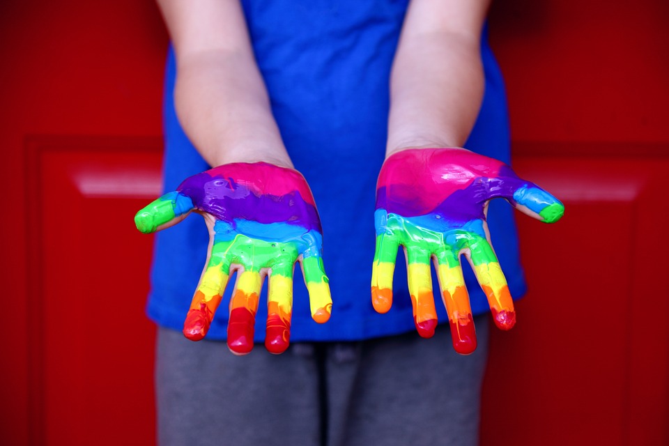 hands painted in rainbow paint