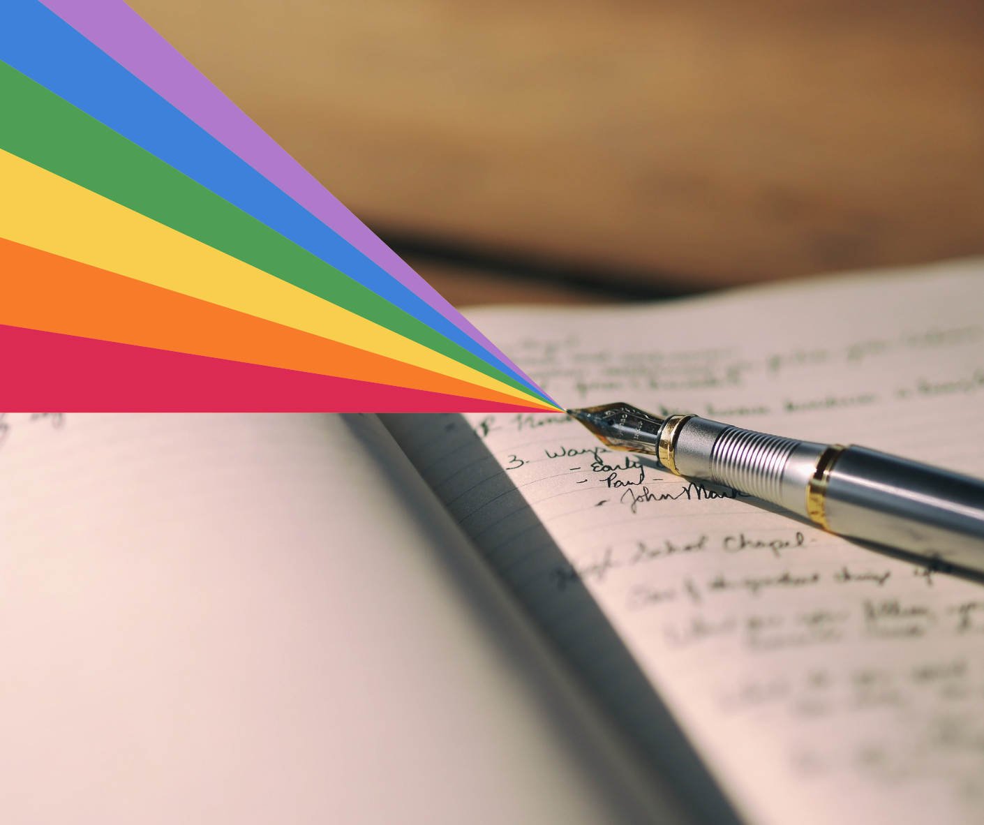 Pen laying on an open book with a rainbow coming from its tip