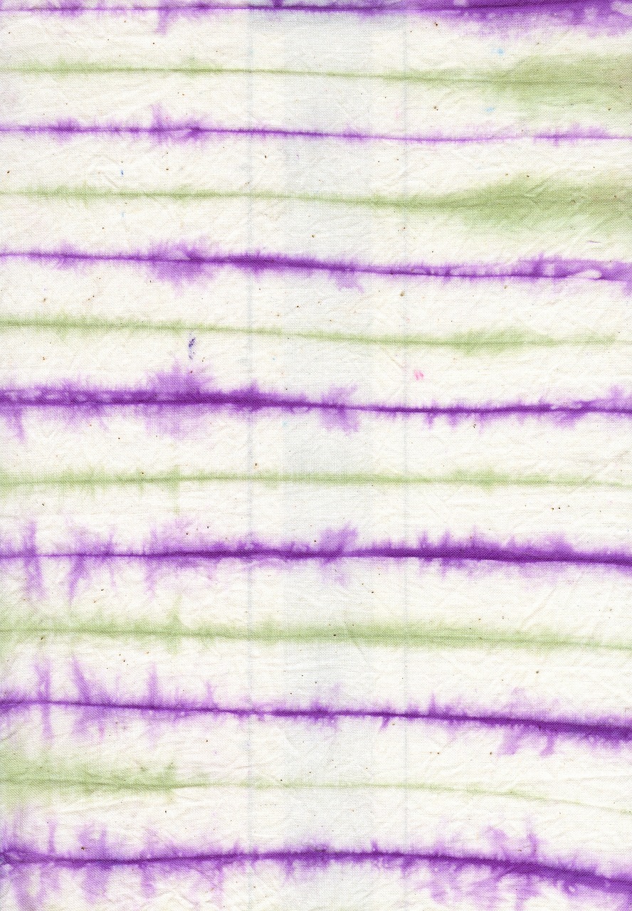 purple and green tie dye lines on white background