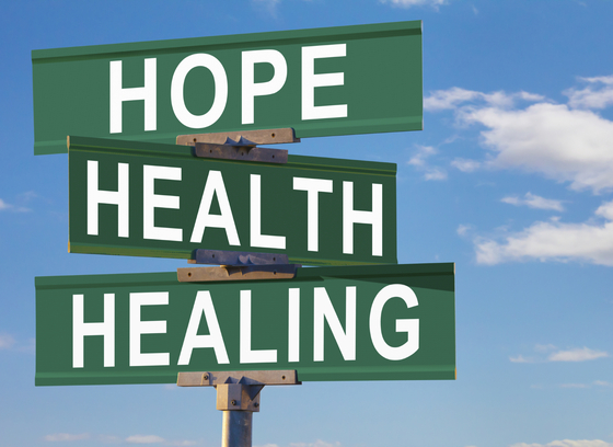 green street signs saying hope, health, healing