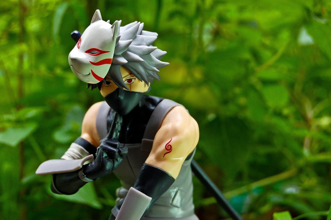 a figurine of Kakashi Hatake in front of a foilage