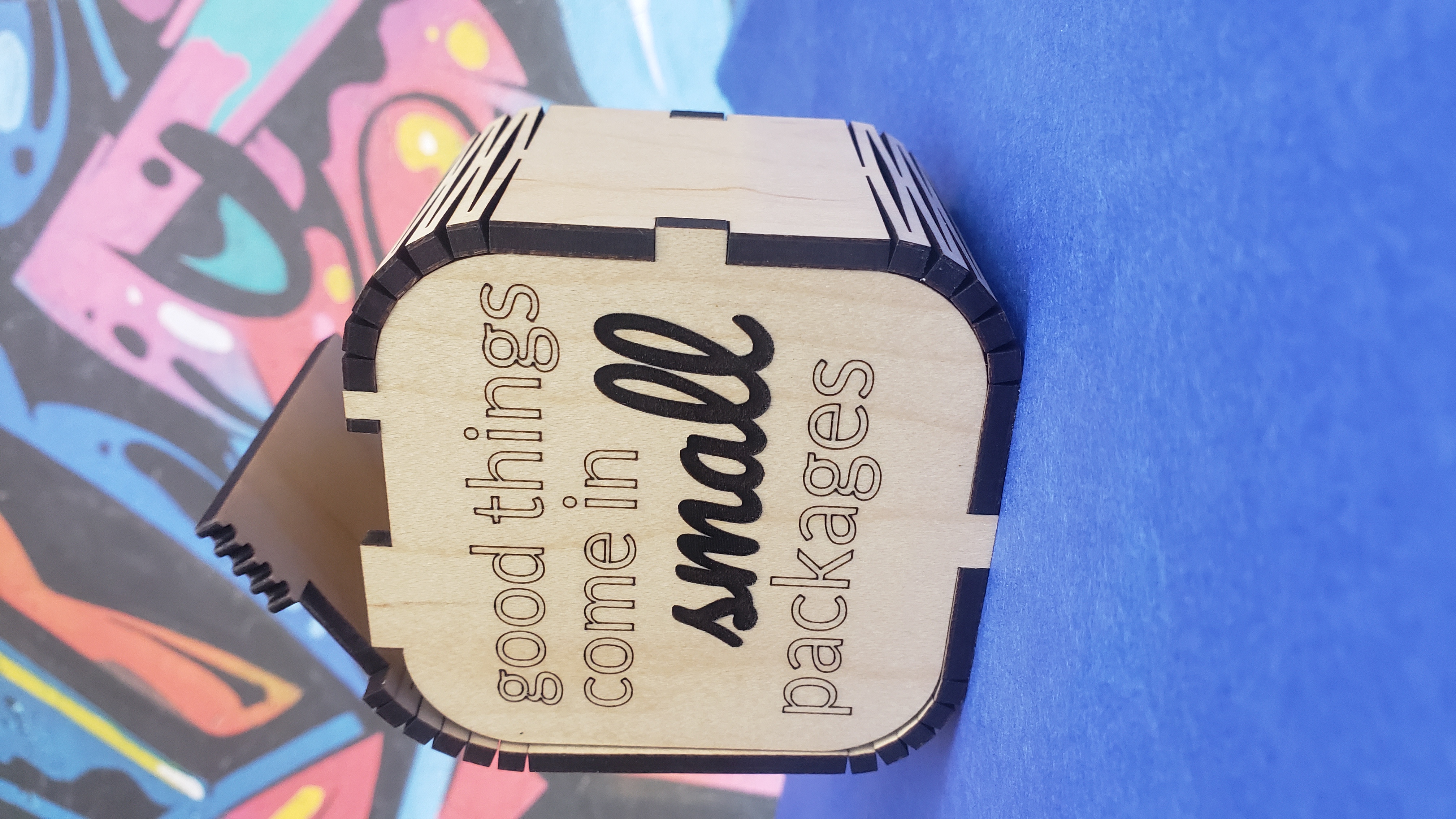 Laser cut wooden box with the words "good things come in small packages" engraved.