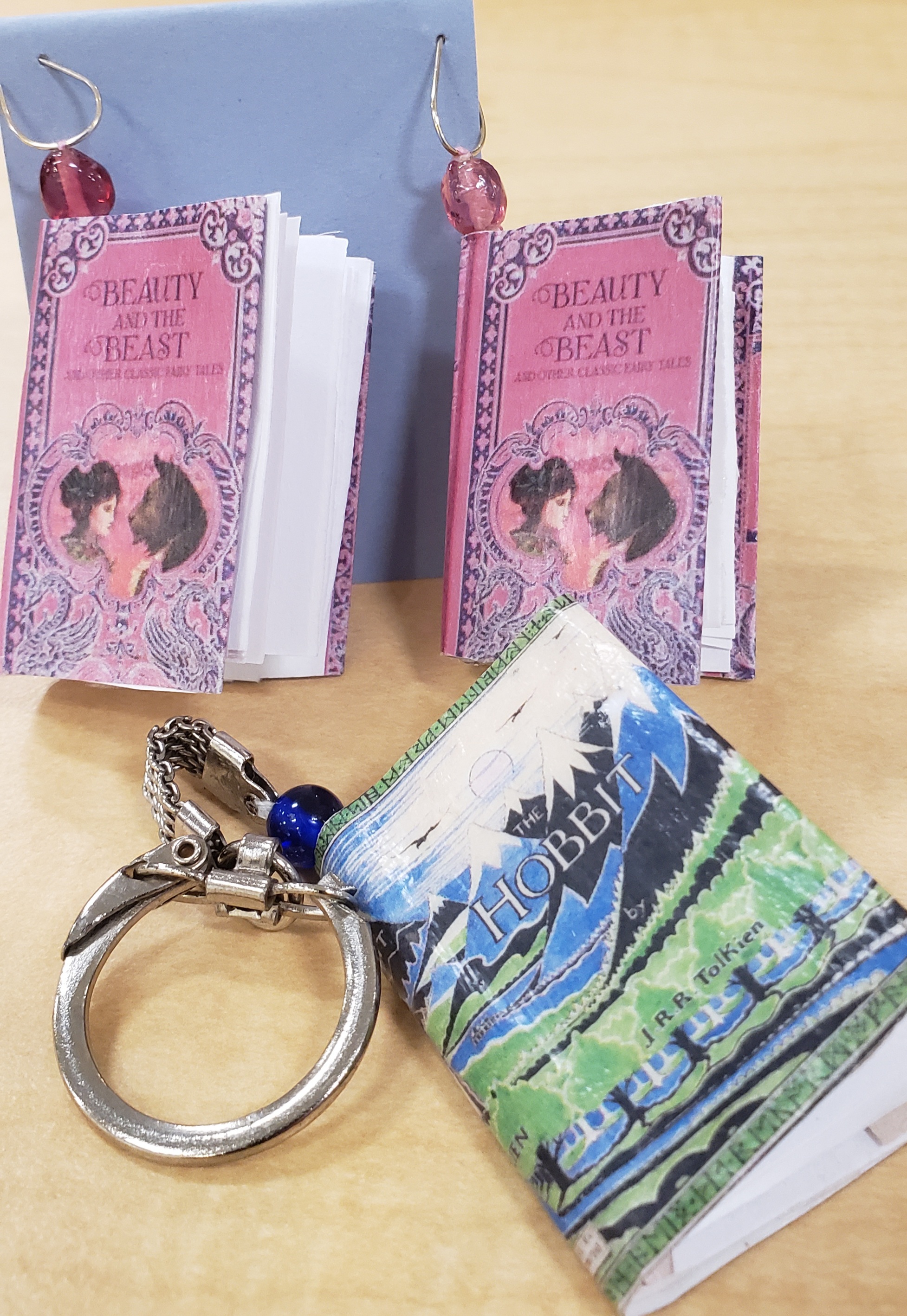 "Beauty and the Beast" book earrings and a "The Hobbit" book keychain