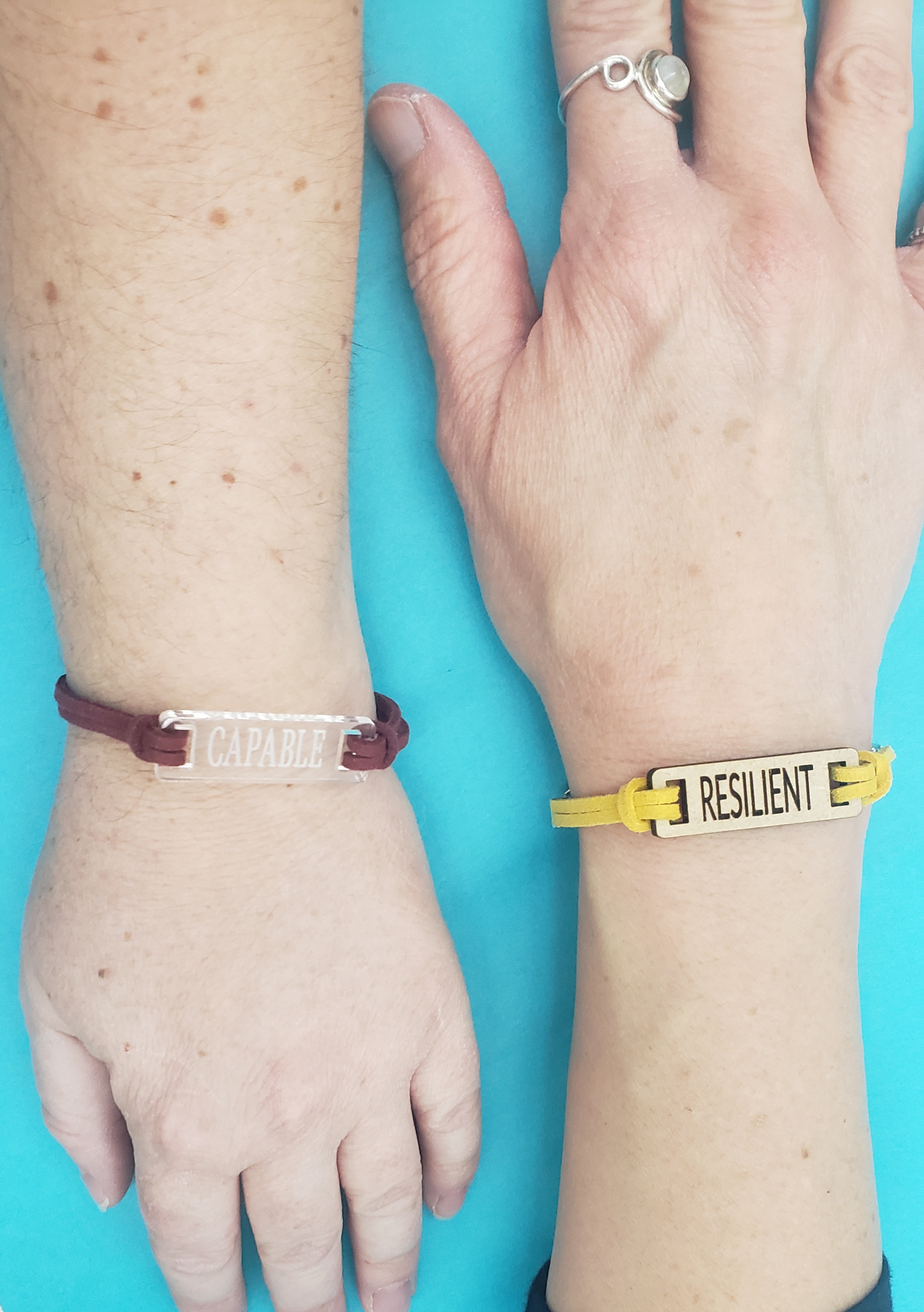Bracelets that read "Capable" and "Resilient"