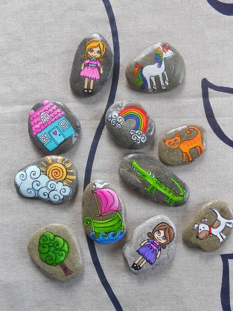 stones with colorful pictures painted on them
