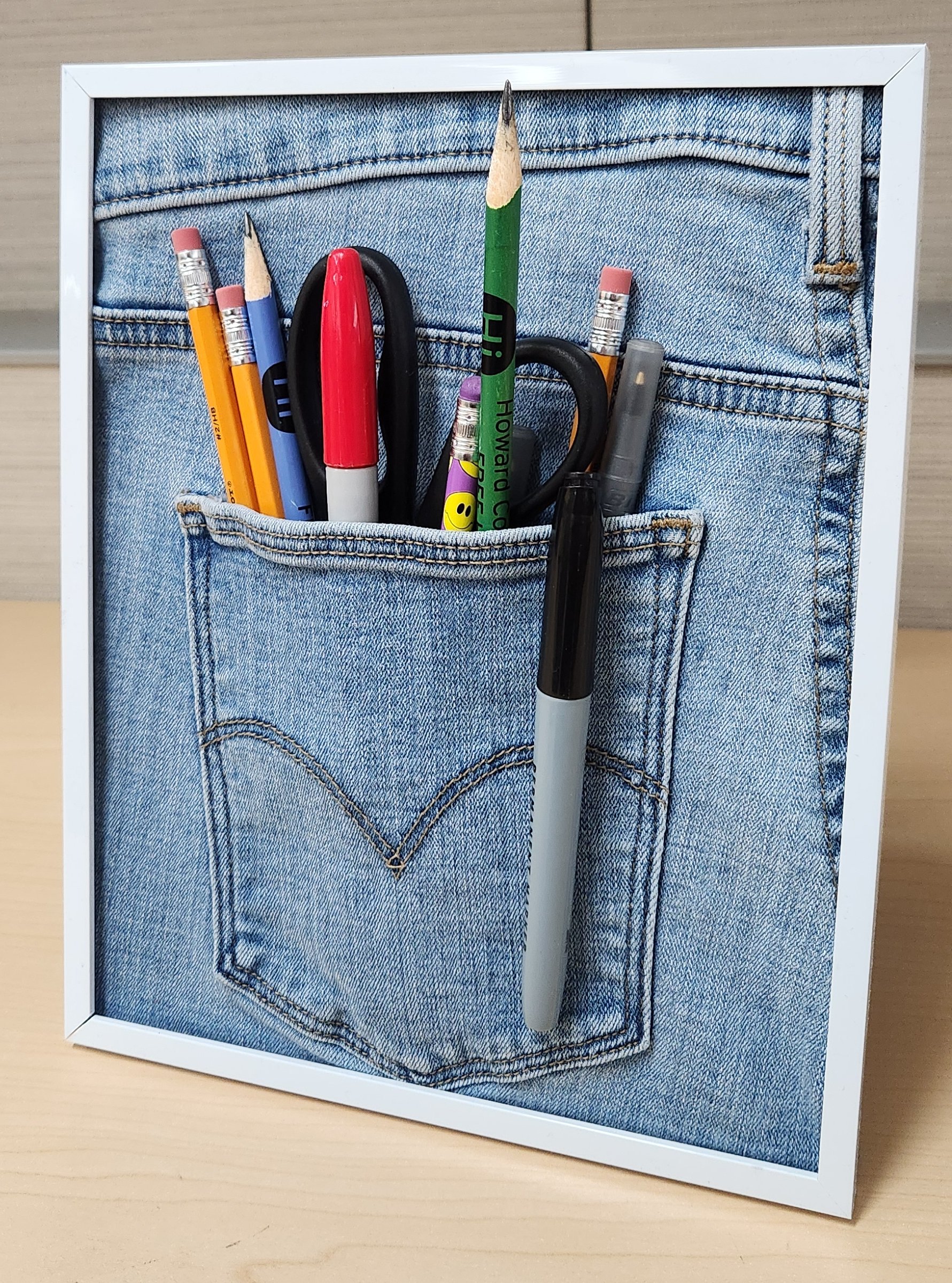 framed denim pocket with pencils and pens