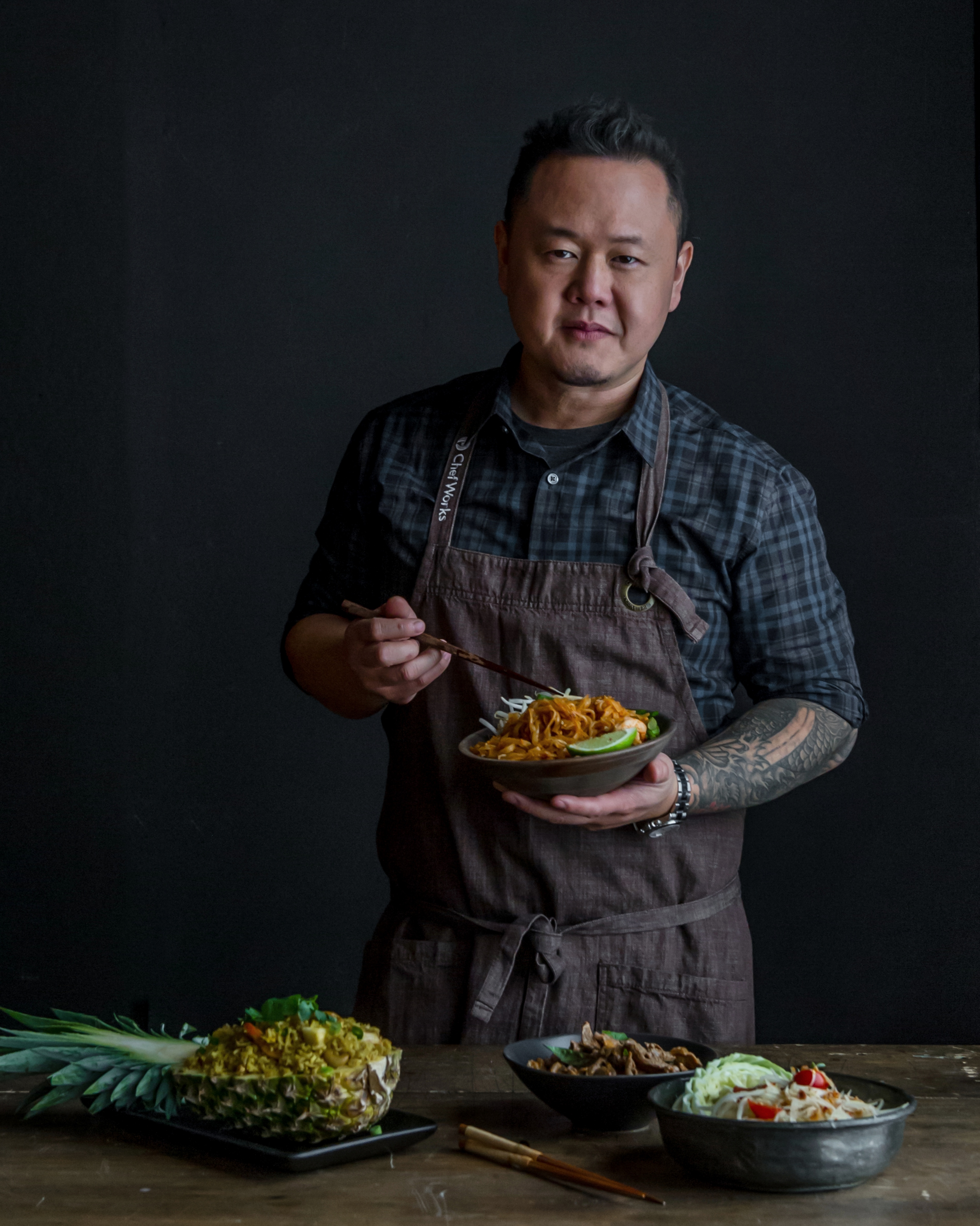 photo of chef Jet Tila with a table of utensils and ingredients