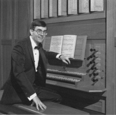 photo of Stephen Ackert sitting at organ