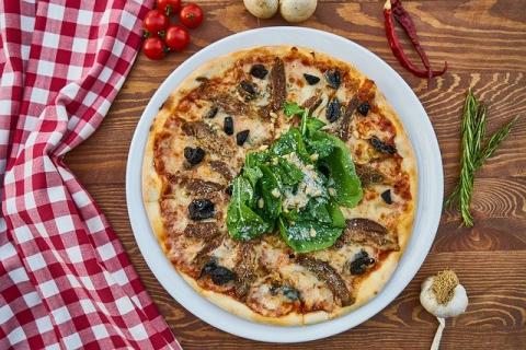 plate of pizza on a wooden table