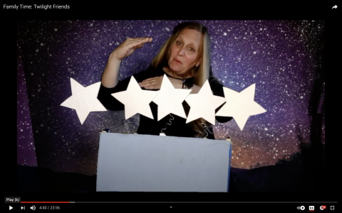 Children's instructor with star-filled laptop theater