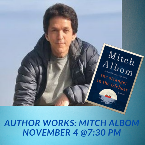 mitch albom wearing a black puffer jacket looks out , a light blue background