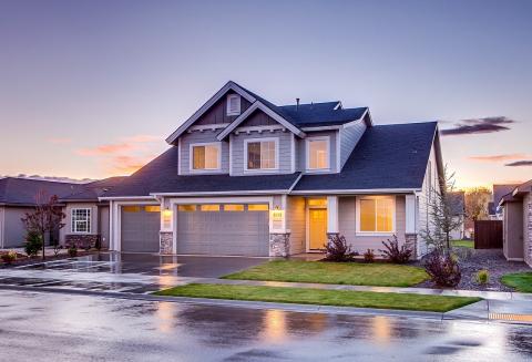 photograph of a gray house at sunset