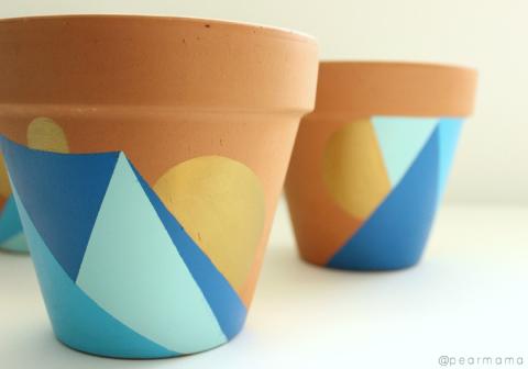 painted terracottapots with geometric designs in plue and orange 