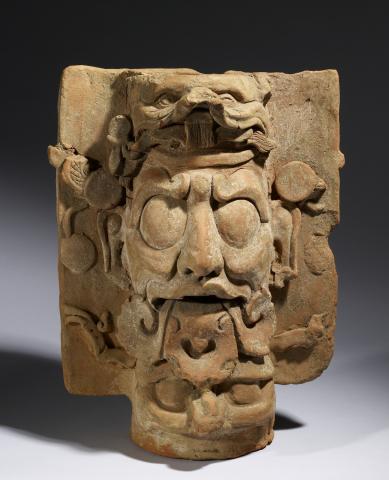 a clay face of a bearded man