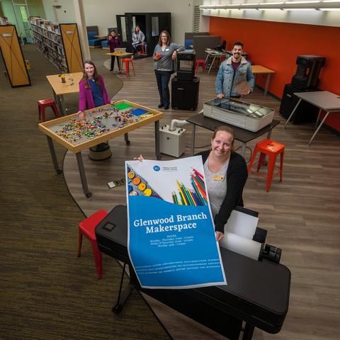 Photo featuring inside of Glenwood Branch makerspace area with staff showcasing the technology.