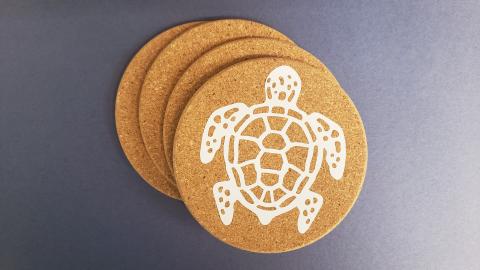 White sea turtle shown on cork coaster