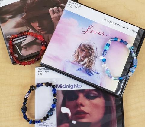 3 beaded bracelets in colors to match Taylor Swift albums: Red (Taylor's Version), Lover, and Midnights
