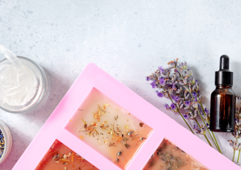 soap making supplies: dried lavender, essential oil, and a silicone mold